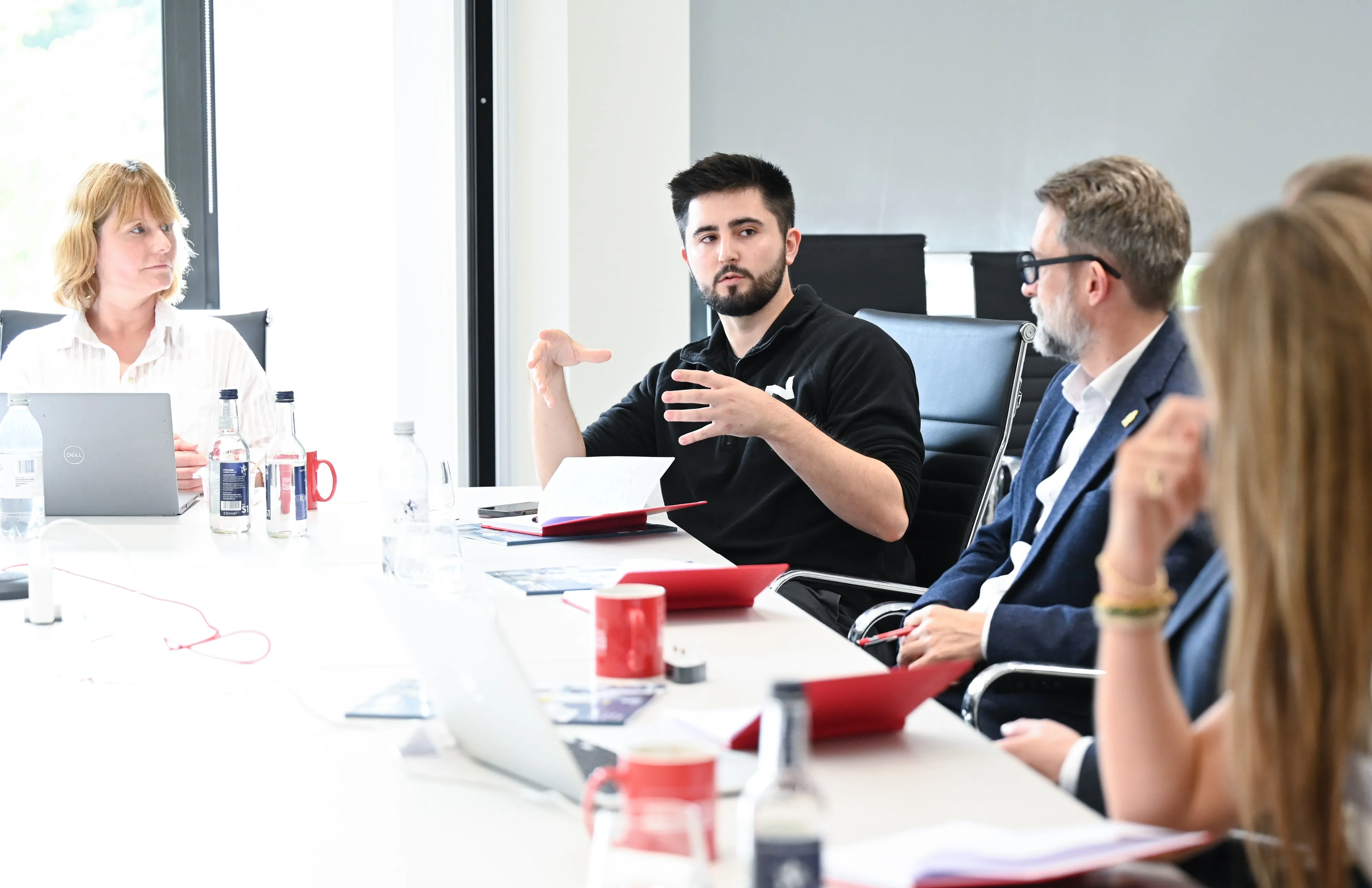 James from Novatura talking to a group of people in an in-person meeting